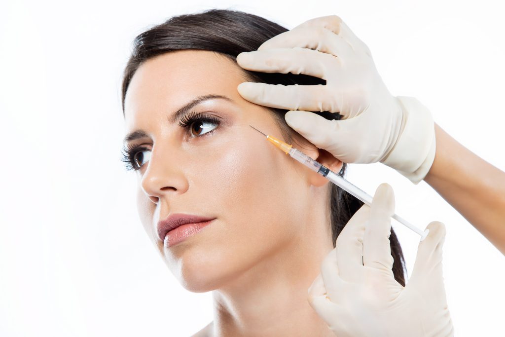 beautiful young woman getting botox cosmetic injection her face min